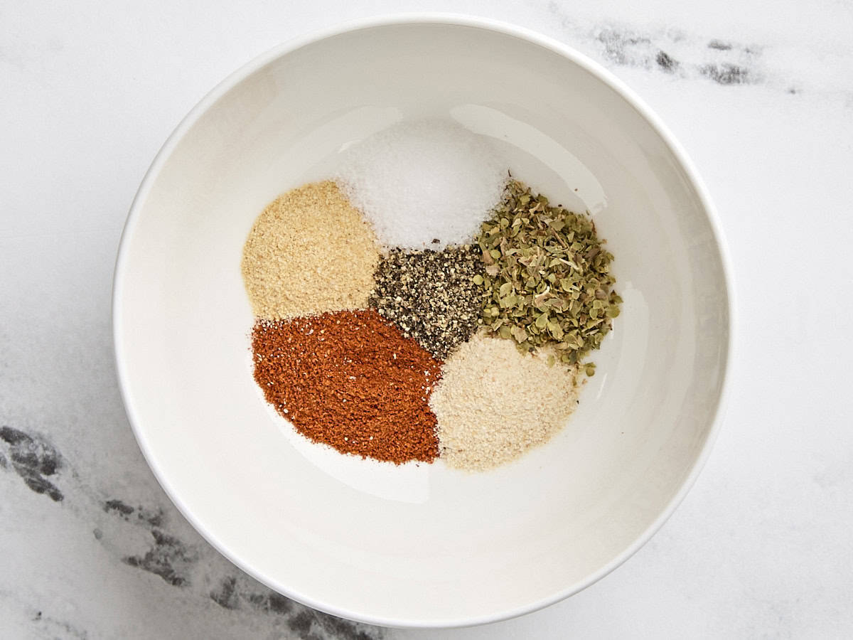 Seasonings for chicken drumsticks in a bowl.